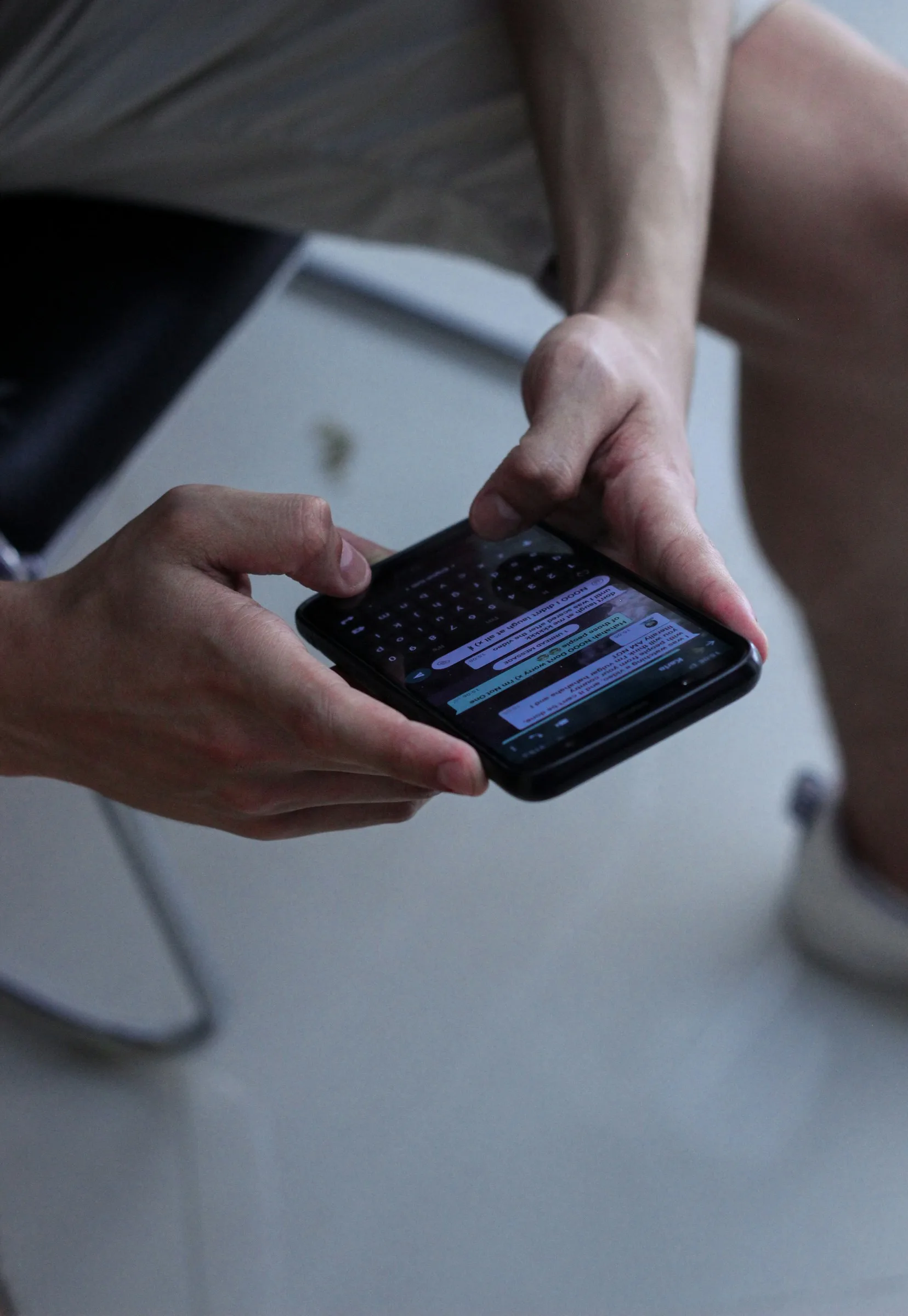 Hands typing a message on a phone